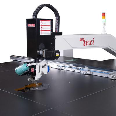 Programmable sewing machine with liftable rotary sewing head and independent drives with extra large sewing field