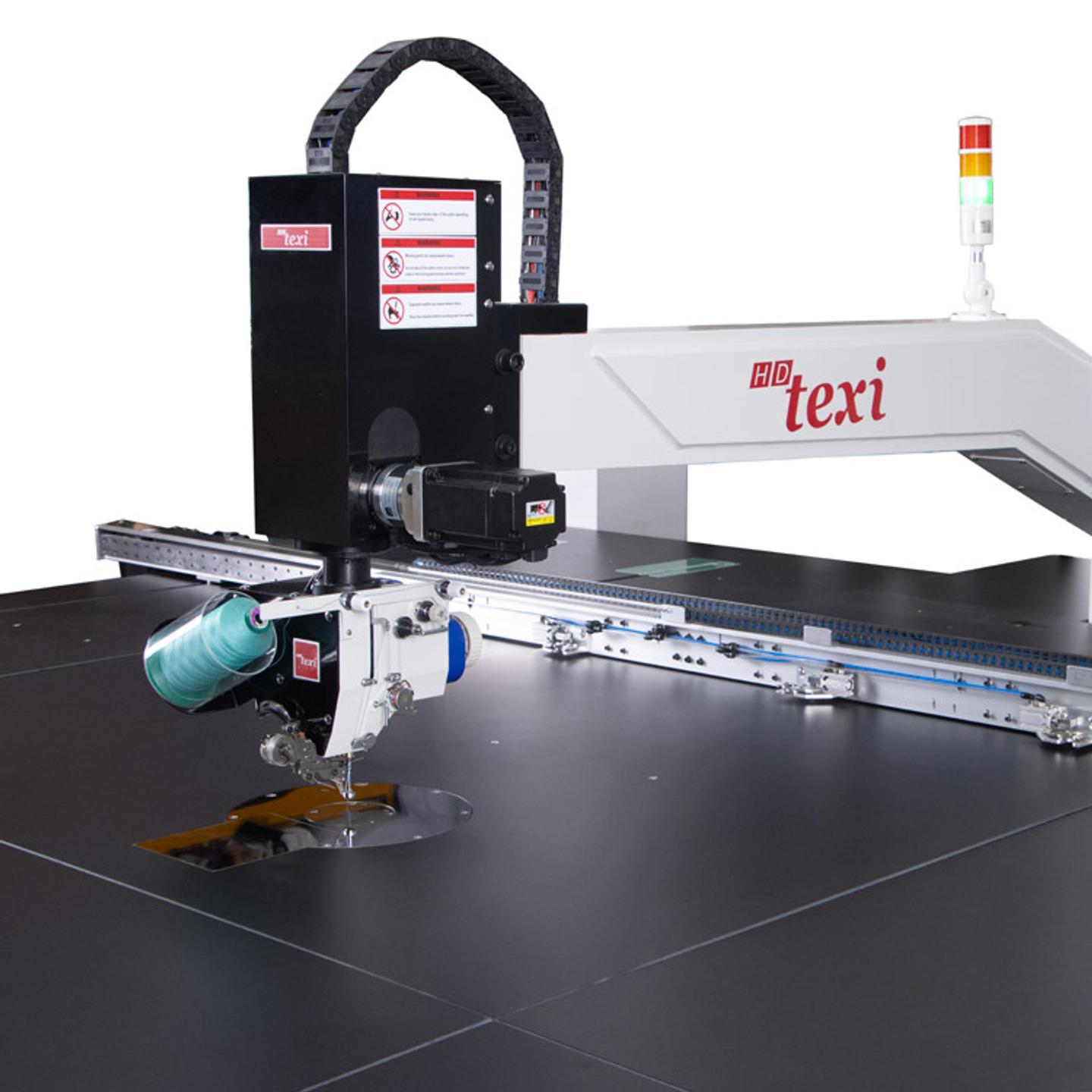 Programmable sewing machine with liftable rotary sewing head and independent drives with extra large sewing field