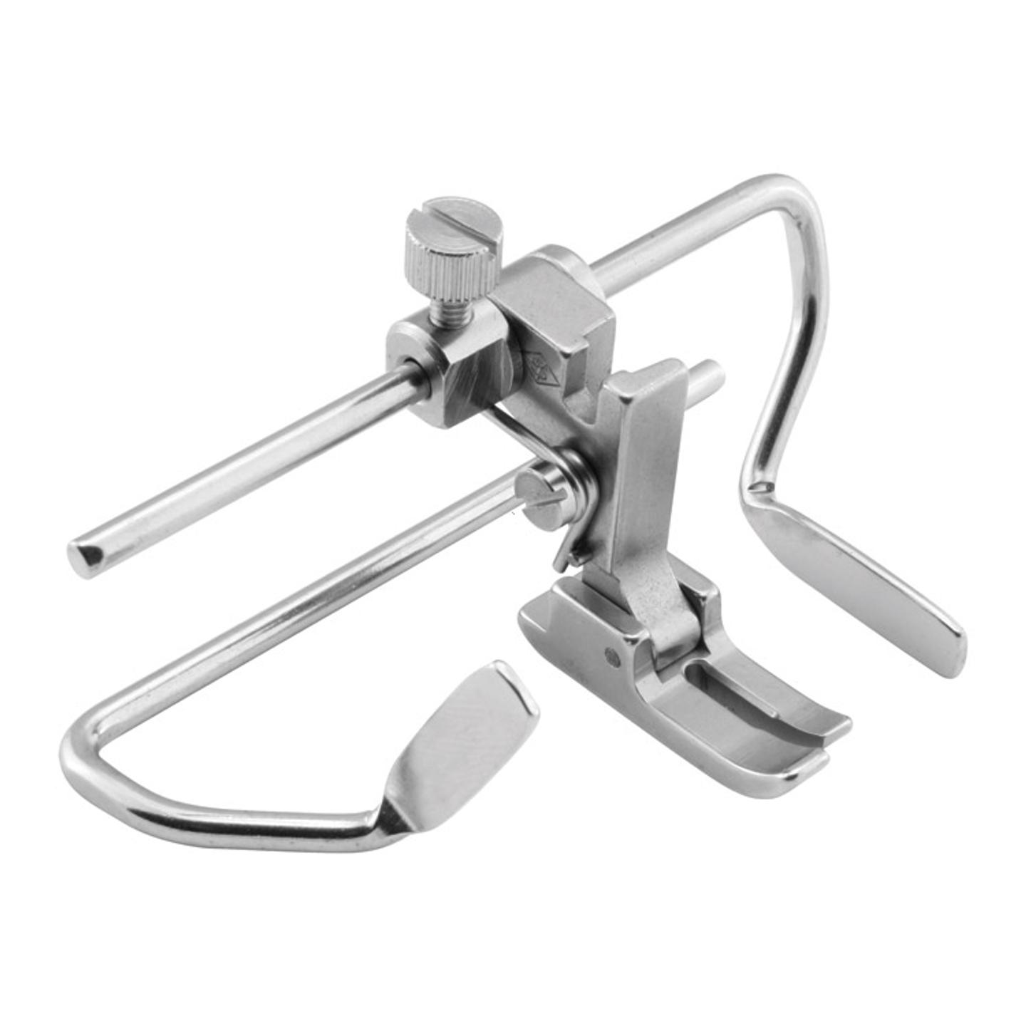 Needle feed foot with right and left gauges